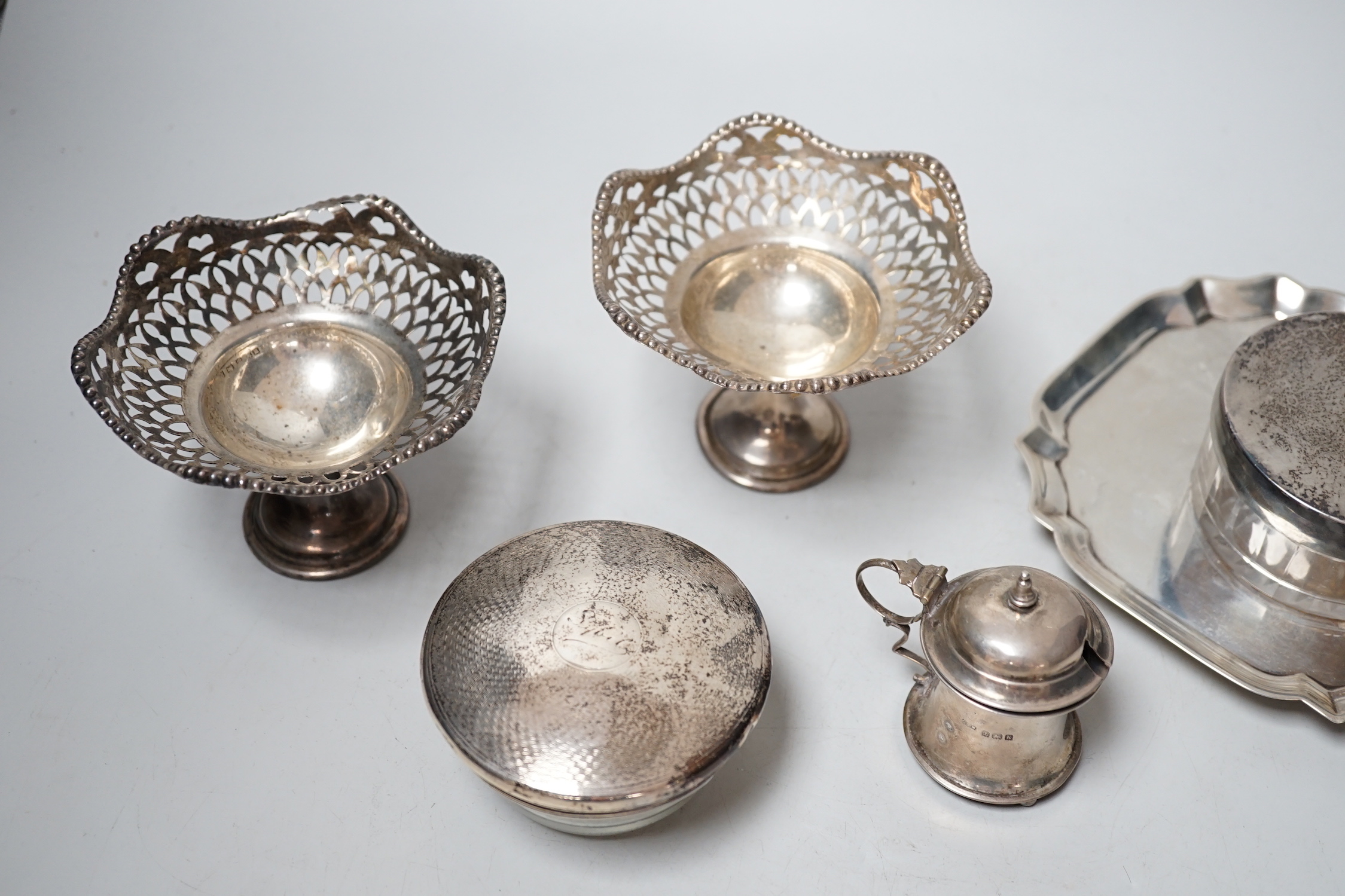 Sundry small silver including a late Victorian silver waiter, Birmingham, 1899, 14.5cm, two silver mounted toilet jars, a silver mustard pot and pair of silver pedestal tazzes.